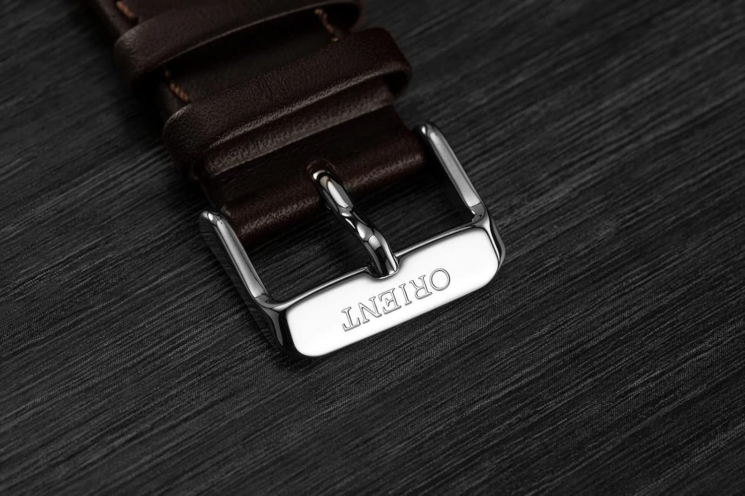 Orient signed tang buckle on brown leather strap
